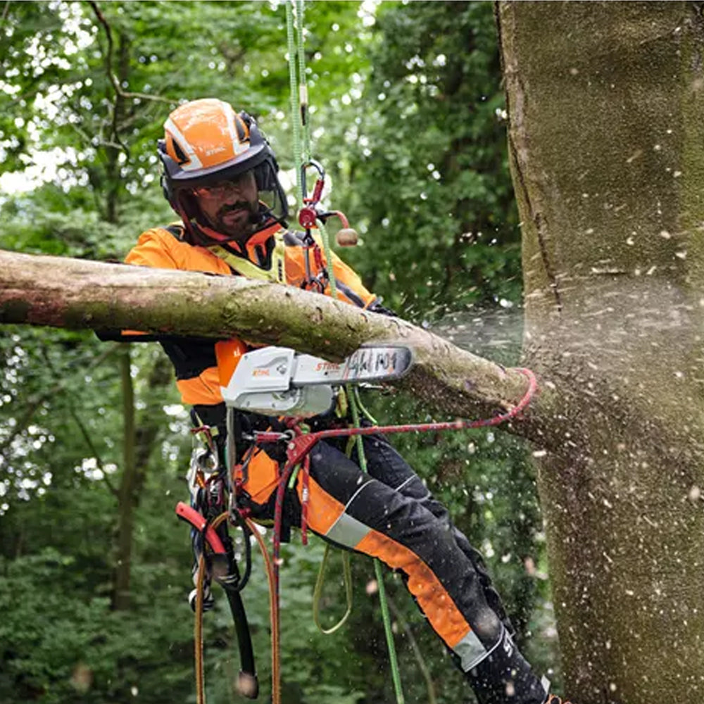 arborist professional using The STIHL MSA 220 T Battery Chainsaw is a high-performance top-handle saw for professional arborists and tree maintenance work. Available at Cannings.