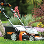 person using the STIHL RMA 510 Battery Lawn Mower AP System available at Cannings. A quiet, high-performance battery mower for medium to large lawns and professional outdoor maintenance.
